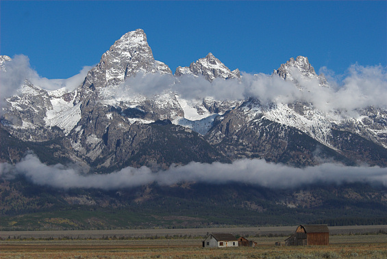 Peaks of the Teton Range from a location known as Mormon Row where old farmstead structures remain on the park site.